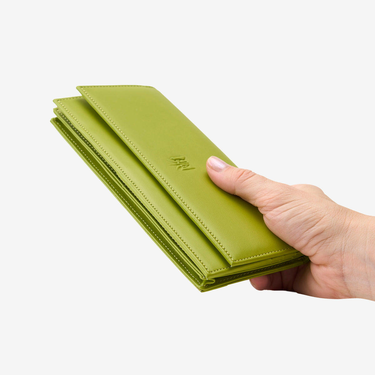 Tusk Lille leather clutch wallet, held in hand – AVOCADO