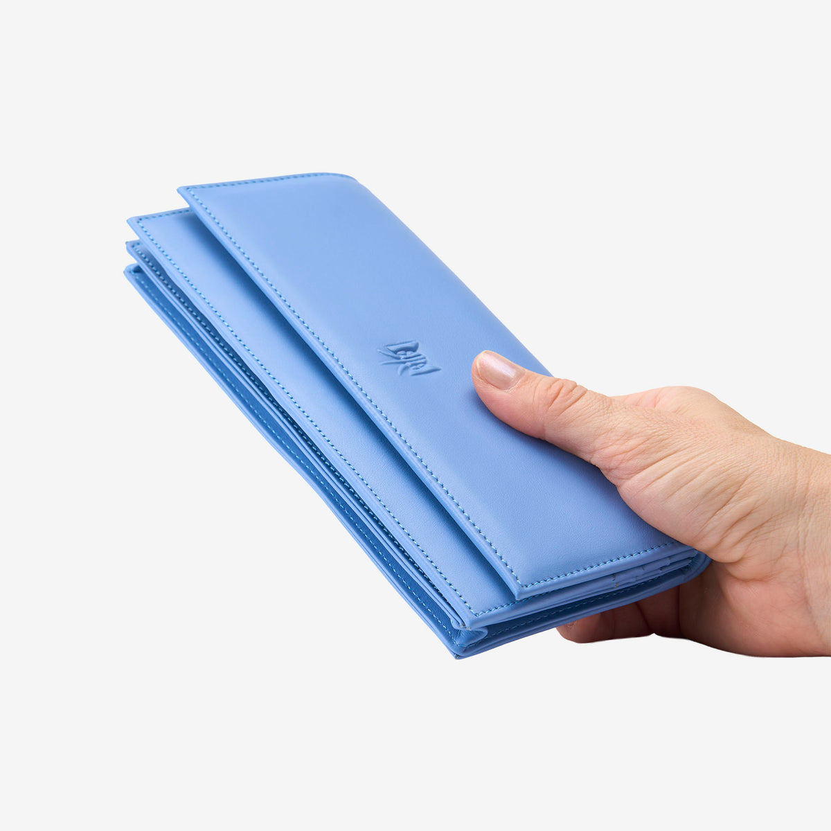 Tusk Lille leather clutch wallet, held in hand – FRENCH BLUE