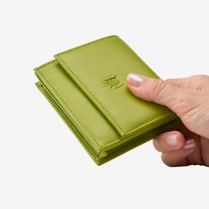 Tusk Lille gusseted French leather wallet in avocado green, held in hand to show its compact size, view two - AVOCADO