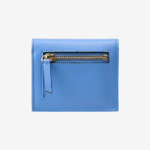 Tusk Lille gusseted French leather wallet in French blue, shown from the back, highlighting the exterior zip pocket - FRENCH BLUE