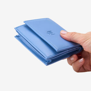 Tusk Lille gusseted French leather wallet in French blue, held in hand to show its compact size, view two - FRENCH BLUE