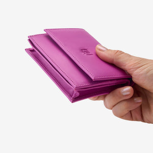 Tusk Lille gusseted French leather wallet in magenta, held in hand to show its compact size, view two - MAGENTA