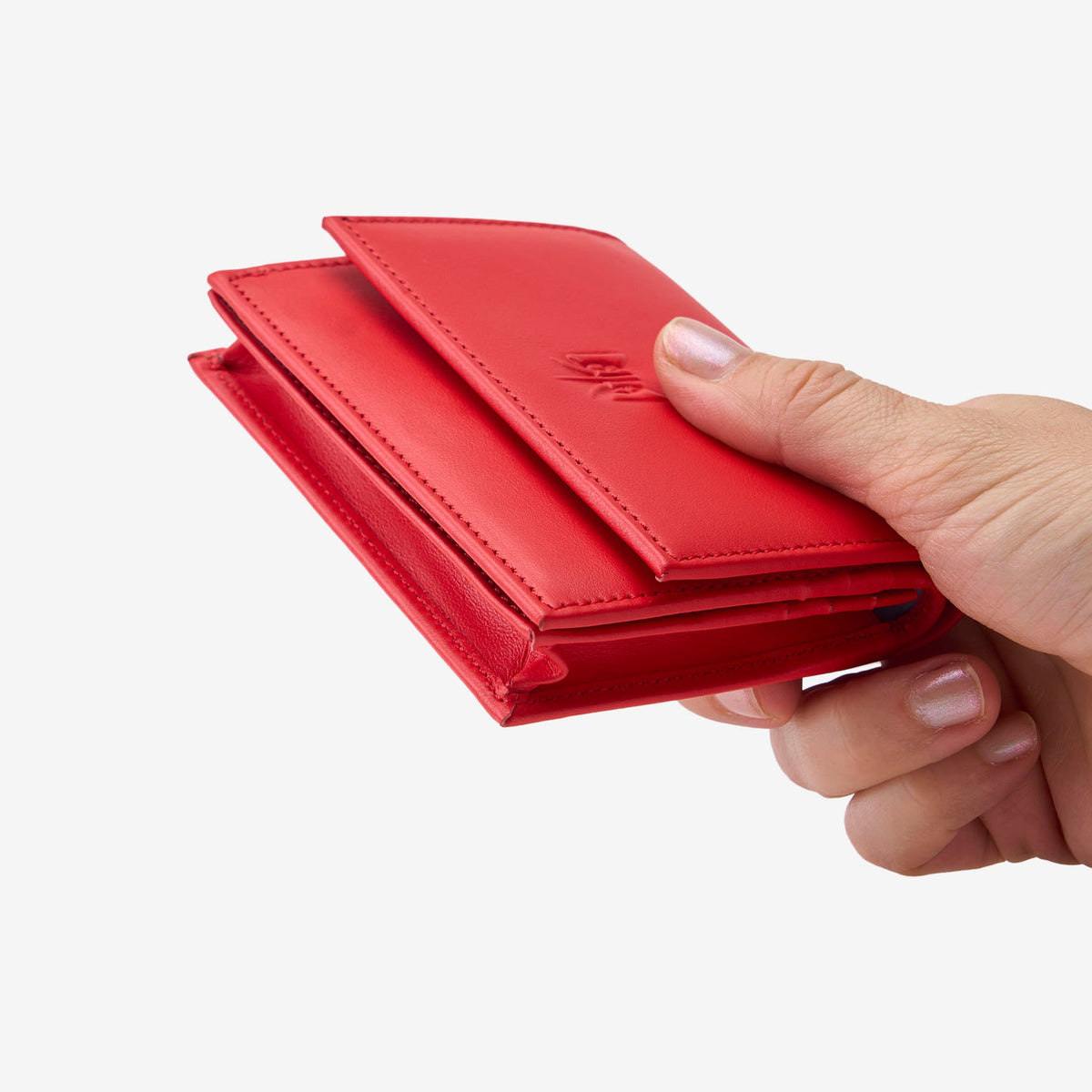 Tusk Lille gusseted French leather wallet in red, held in hand to show its compact size, view two - RED