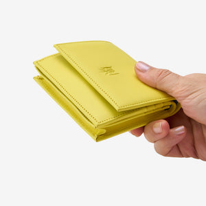 Tusk Lille gusseted French leather wallet in yellow Sun, held in hand to show its compact size, view two - SUN