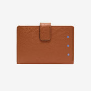 Brown leather wallet with a flap on a light gray background - TOAST