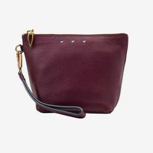 Maroon leather clutch with a strap on a white background - OXBLOOD