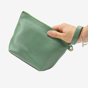Green pouch held by a hand on a white background - SAGE