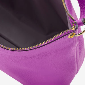 Close-up of a purple handbag with a gold zipper on a white background - MAGENTA