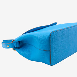 Bottom of blue Italian leather handbag on a light gray background -AZURE