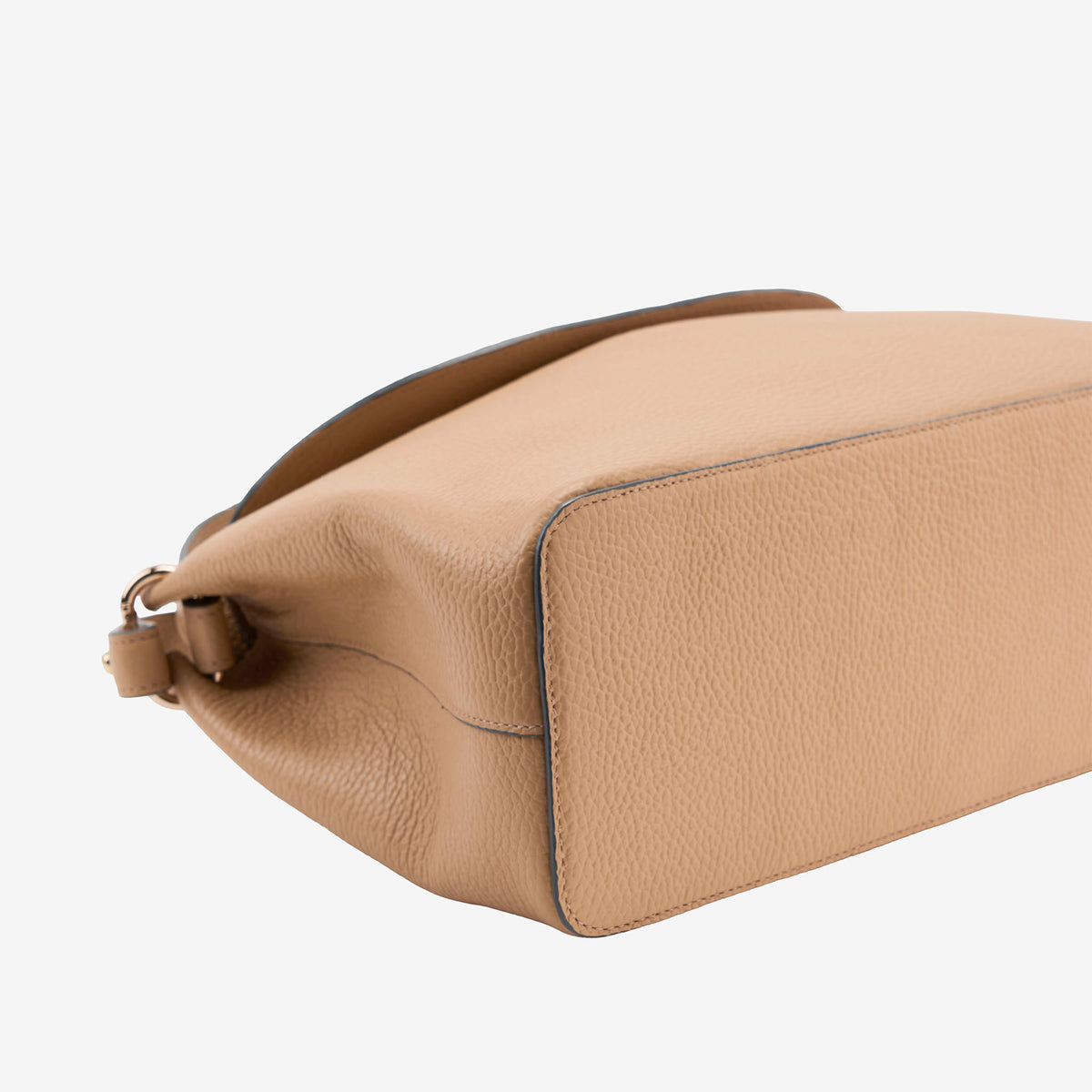 Bottom of a beige Italian leather bag on a white background - SAND