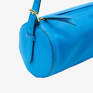 Blue handbag with a gold buckle on a white background
