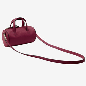 Maroon handbag with a strap on a white background - OXBLOOD