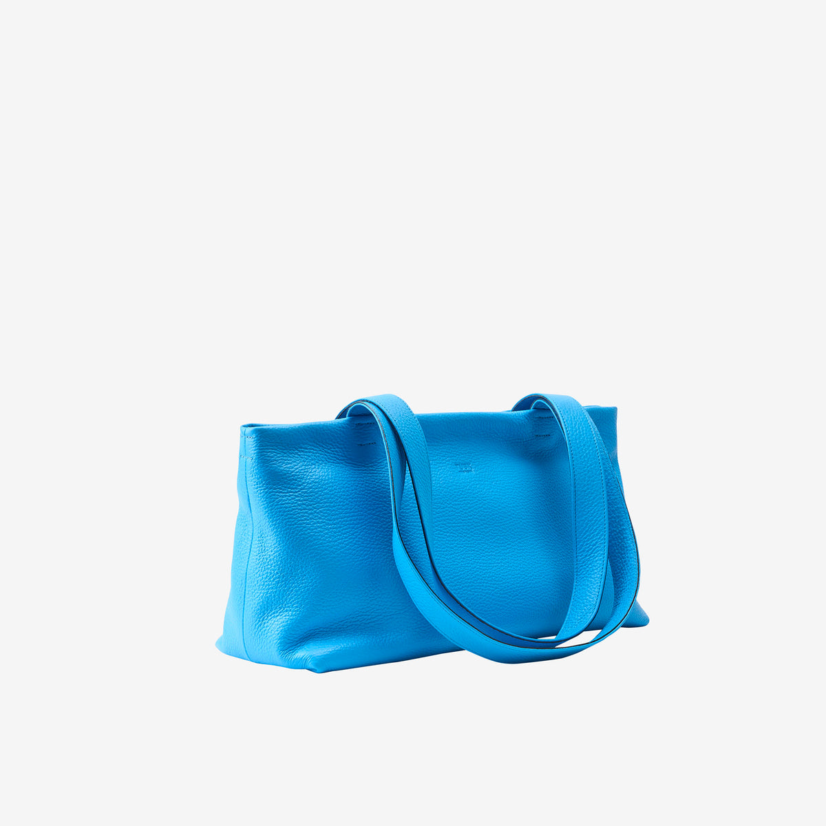 Side view of blue leather tote bag with soft structure and long straps - AZURE