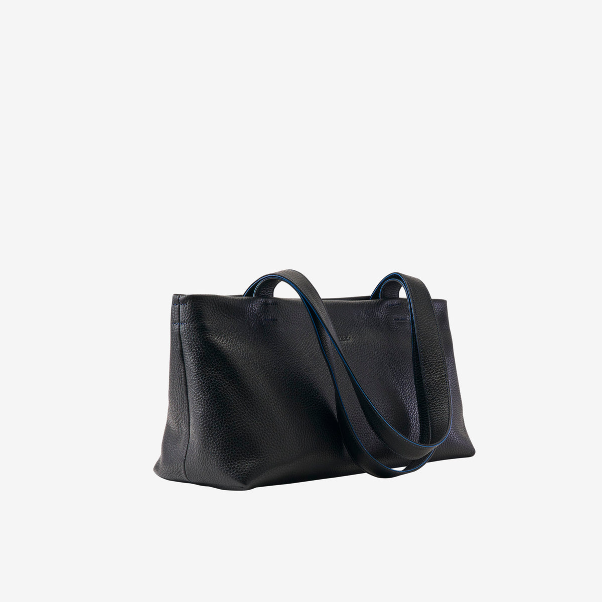 Side view of black leather tote showing soft structure and clean silhouette - BLACK