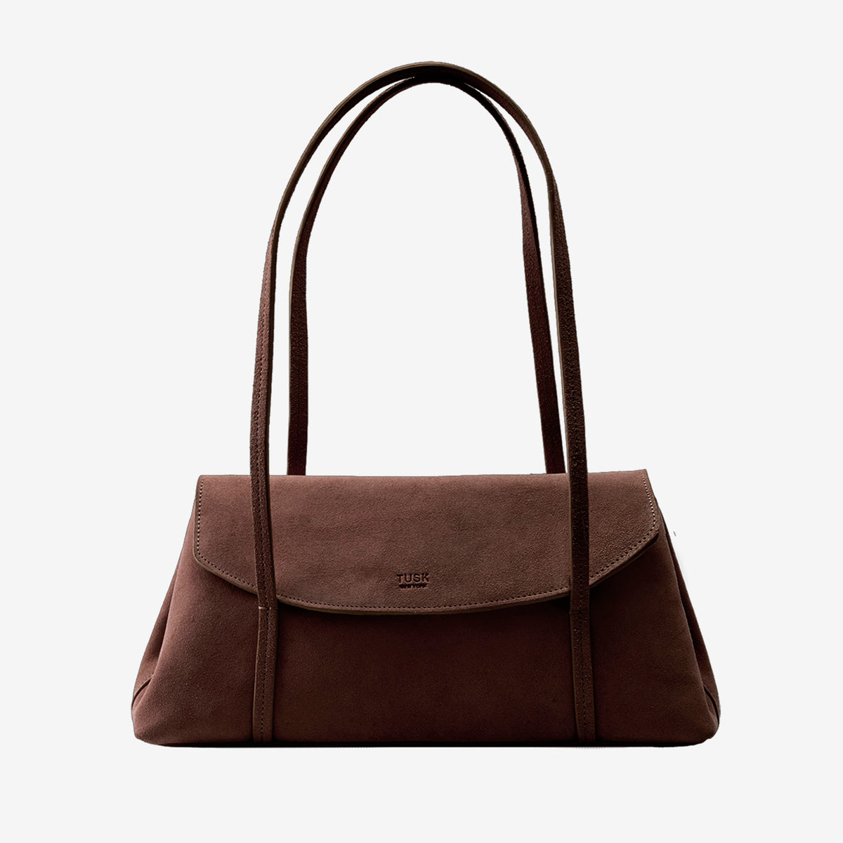 A dark brown suede shoulder bag featuring an envelope flap closure with an embossed Tusk logo and double shoulder straps, centered against a plain light gray background - BROWN