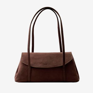 A dark brown suede shoulder bag featuring an envelope flap closure with an embossed Tusk logo and double shoulder straps, centered against a plain light gray background - BROWN