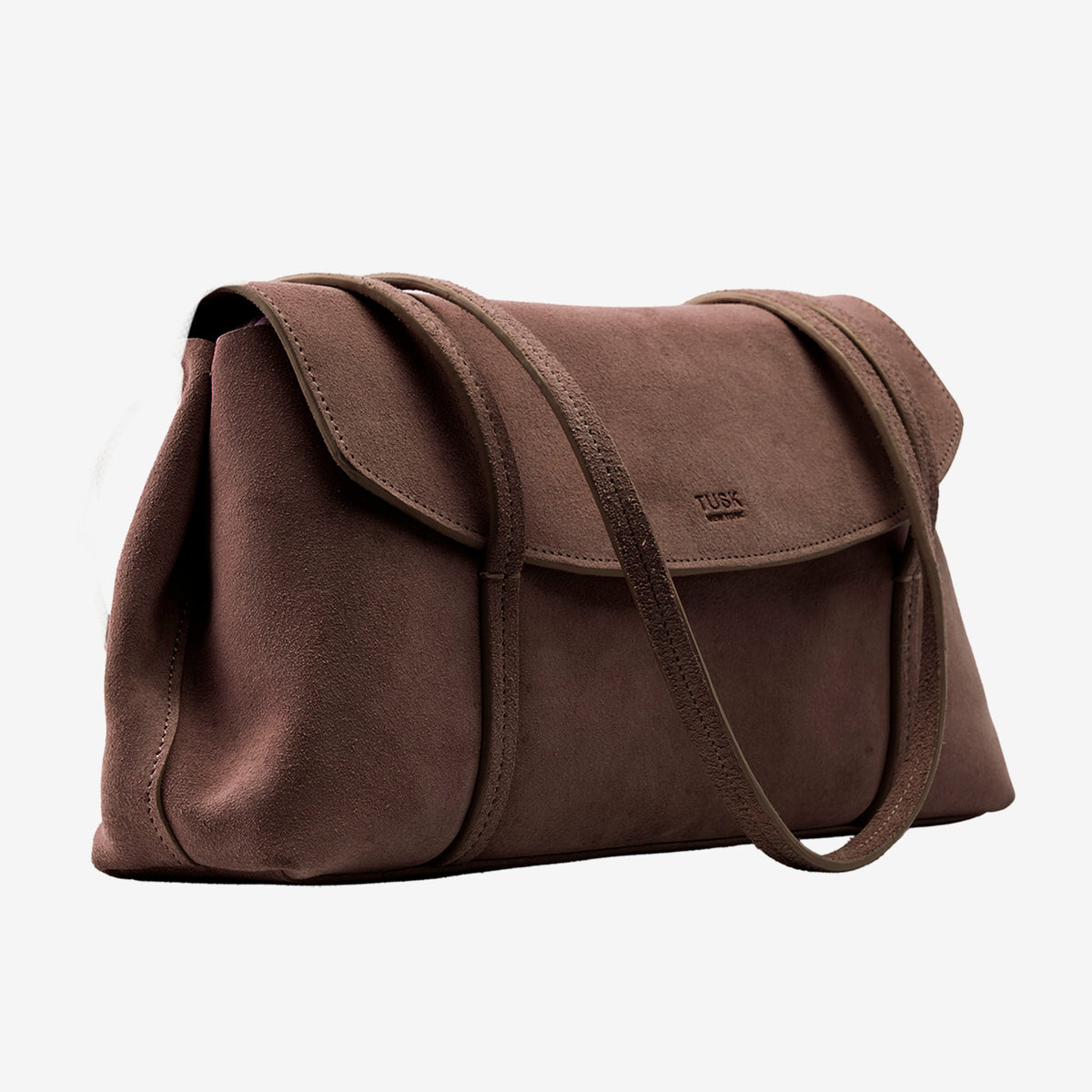 A brown suede shoulder bag with a flap closure and a single shoulder strap, shown on a plain light gray background. The brand name 'TUSC' is embossed on the front of the flap - BROWN