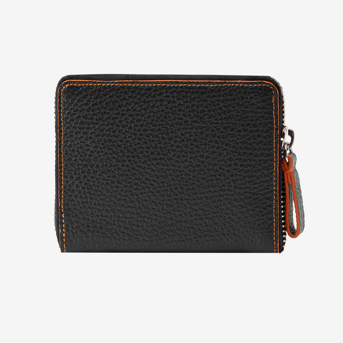 Back view of the Tusk Amsterdam men's zip-around wallet in black pebble leather, showcasing bright orange contrast perimeter stitching and a black leather zipper pull tab with orange trim on a white background - BLACK