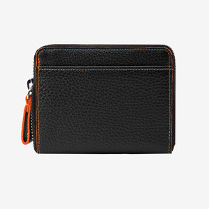 Tusk Amsterdam leather zip-around wallet in black pebble leather, featuring a compact design with bright orange contrast stitching and an orange leather zipper pull tab on a white background - BLACK