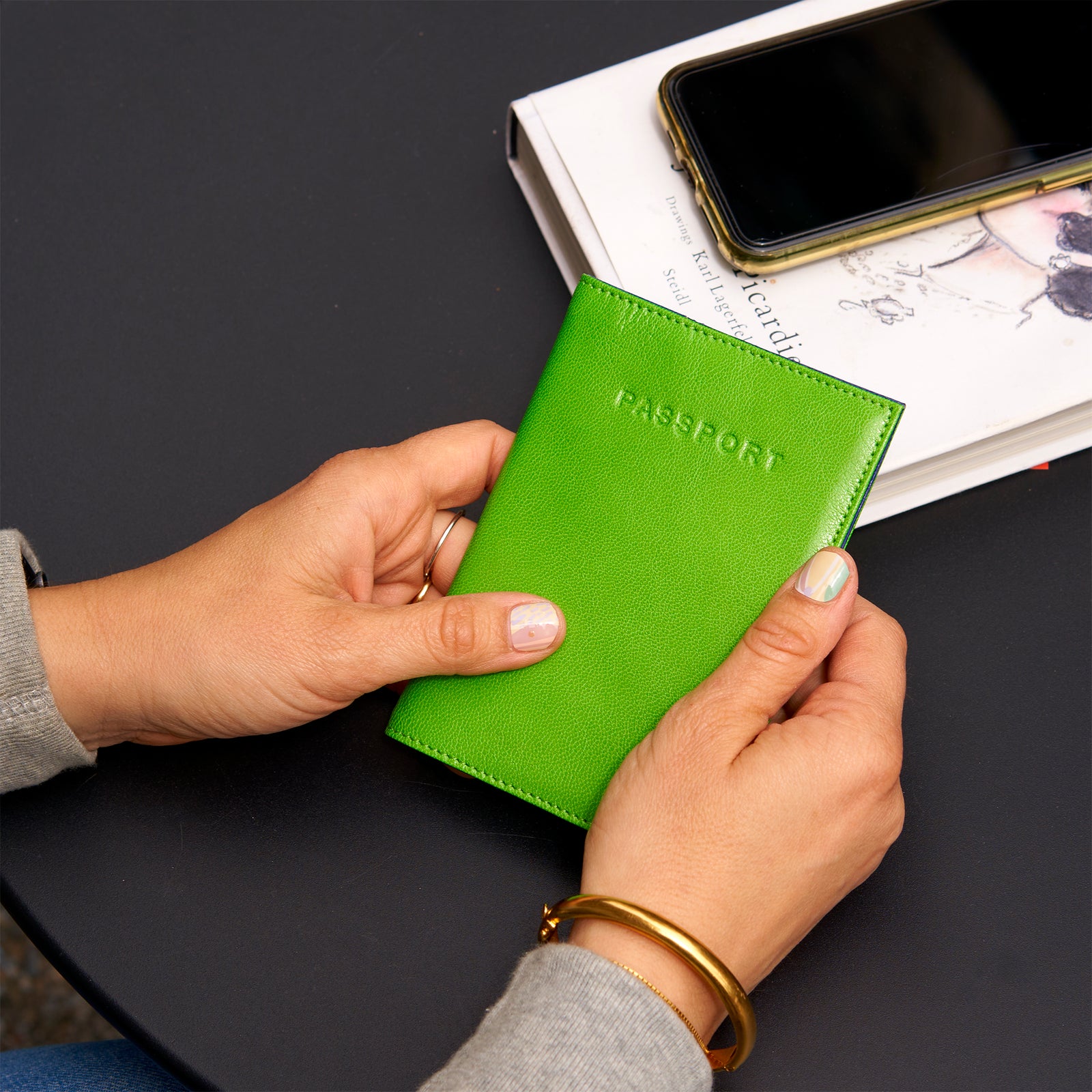 Green passport holder with 'PASSPORT' text on a white background -GRASS/INDIGO